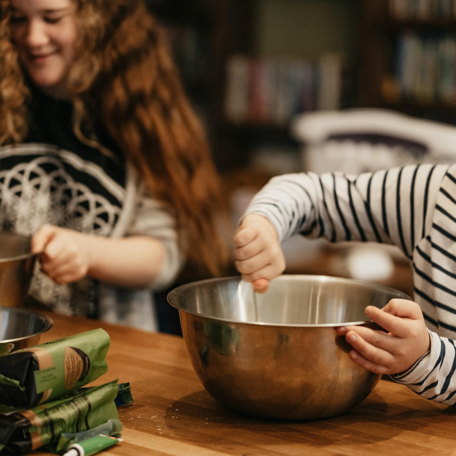 Community members collaborating in a modern kitchen space, sharing recipes and methods